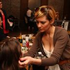 A stylist preps models for Project Runaway - a fashion show to raise funds for at-risk youth.